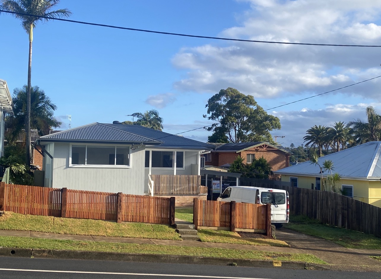 Weatherboard home with freshly painted grey exterior and white window trims