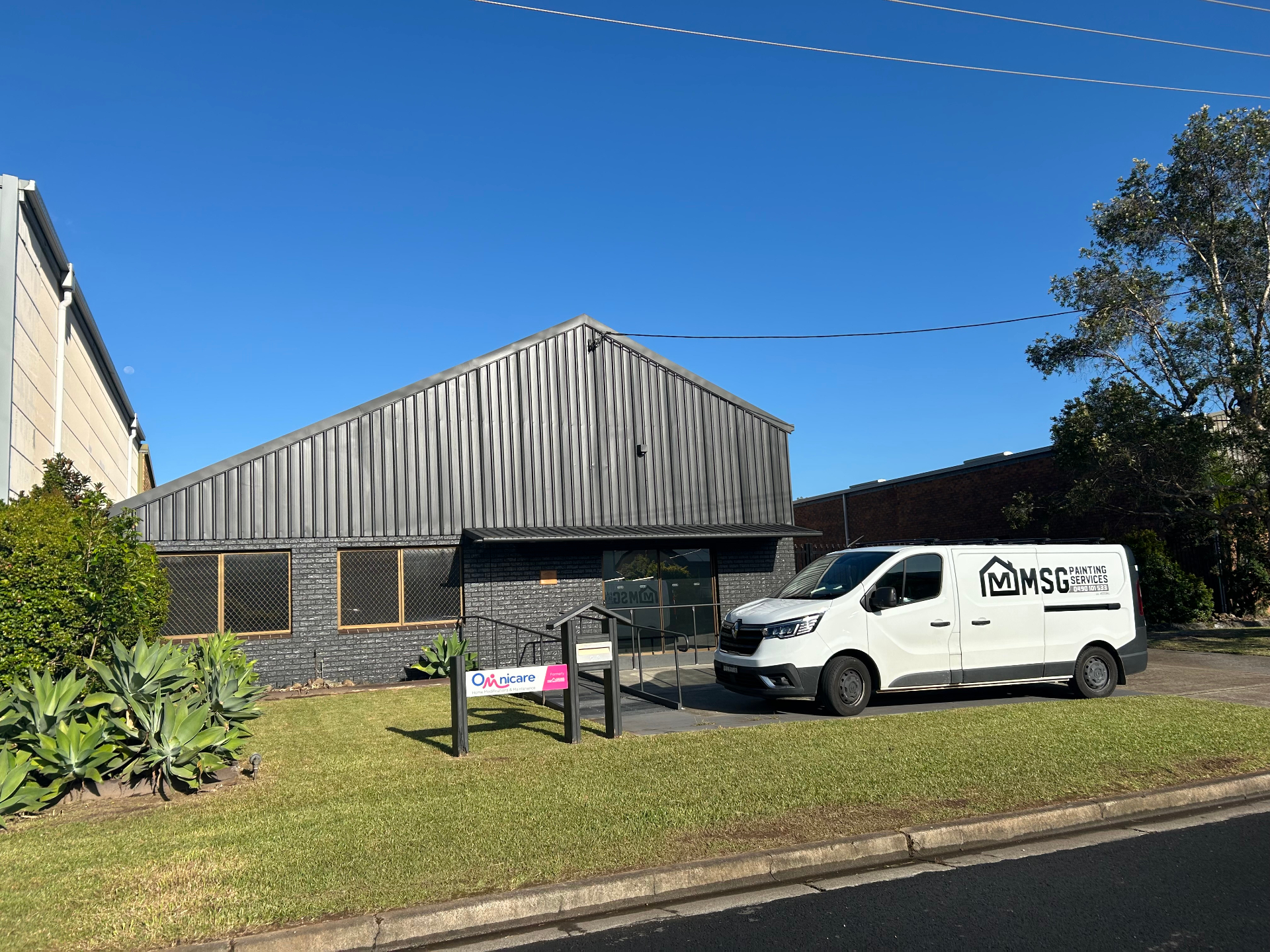 Commercial painting project with MSG Painting Services van on site