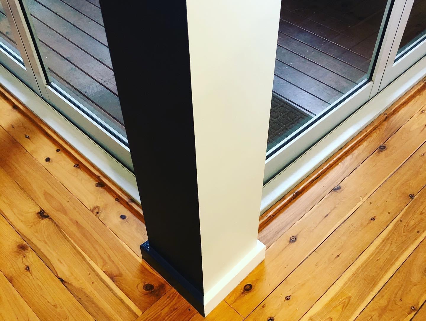 Two-tone black and white interior column with razor-sharp paint lines