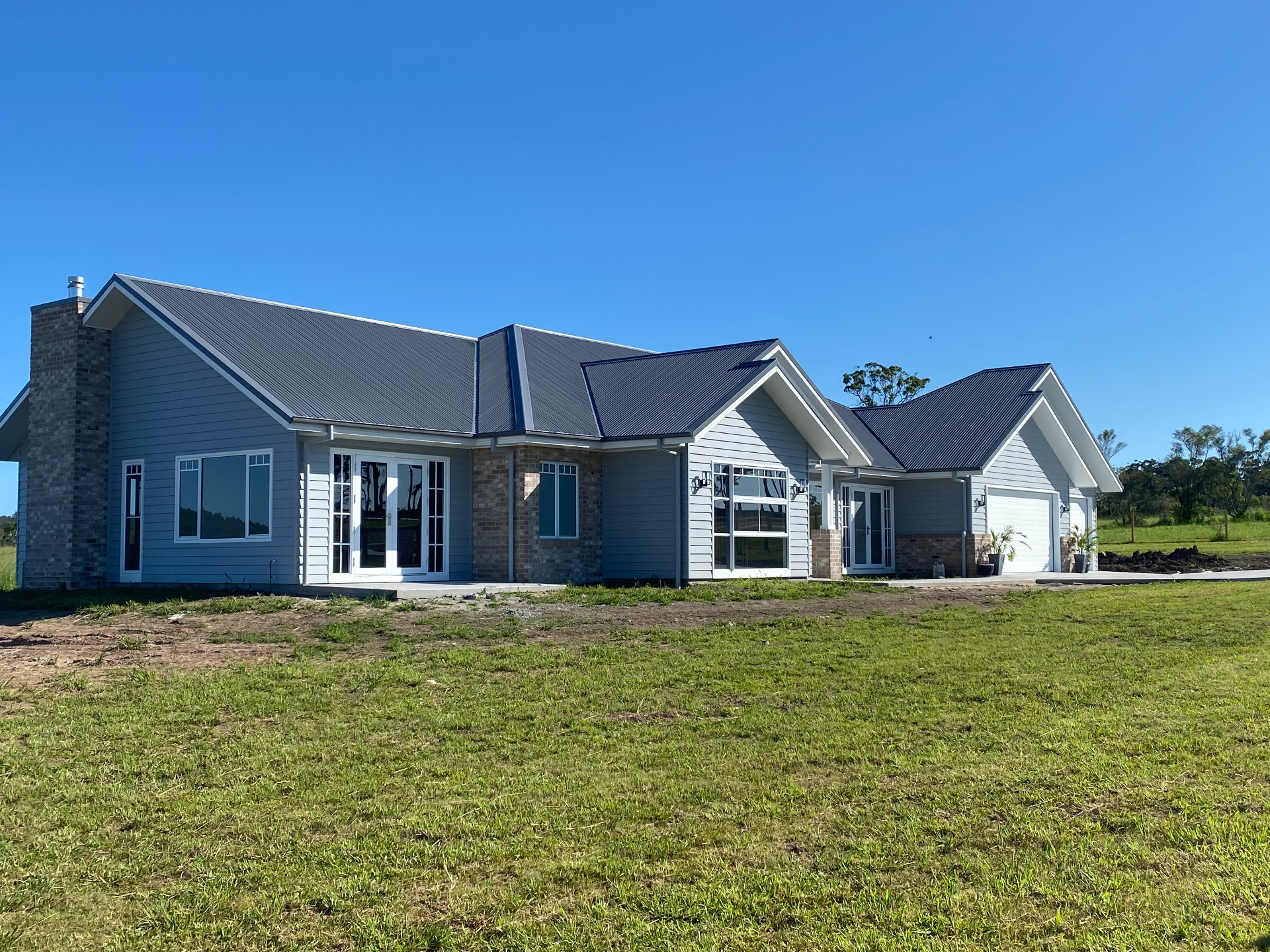 Large rural residence with completed exterior paint finish